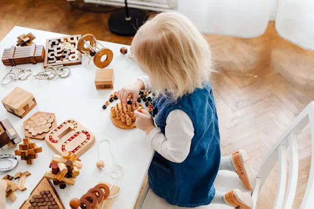 girl playing with sensory toys on a table