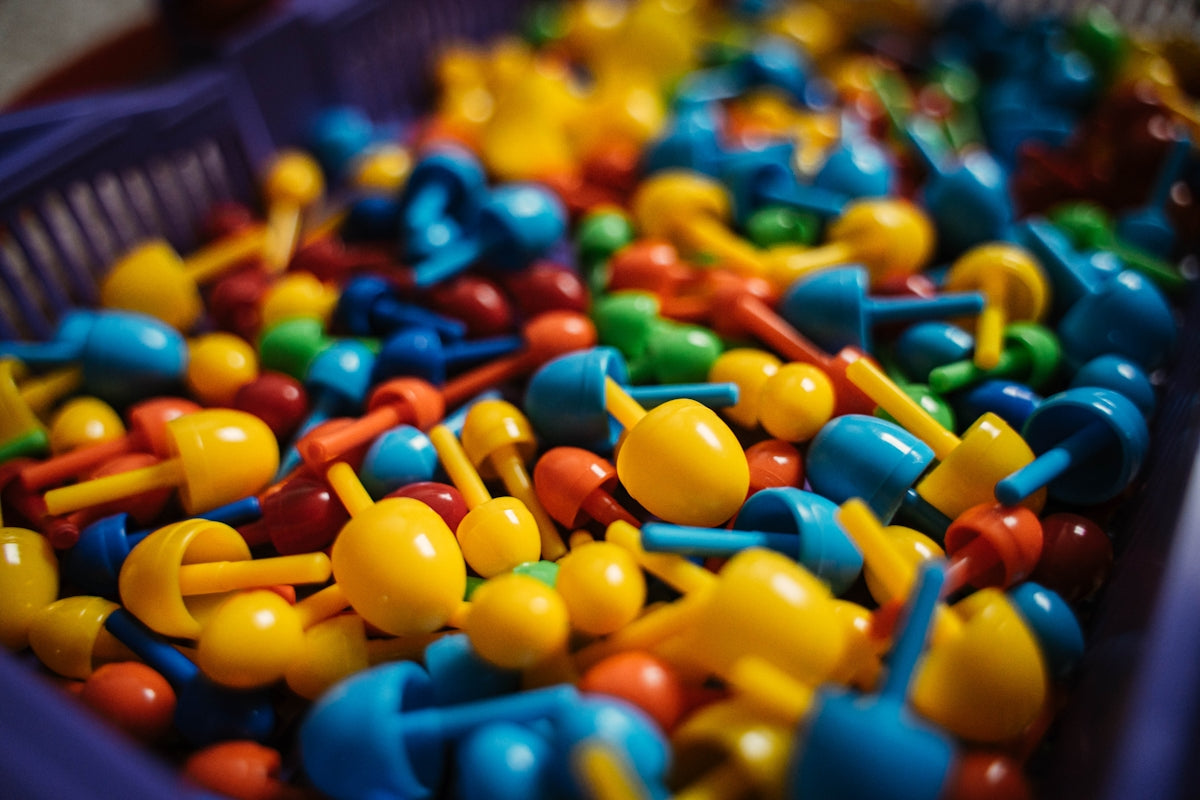 a bin filled with lots of colorful plastic toys