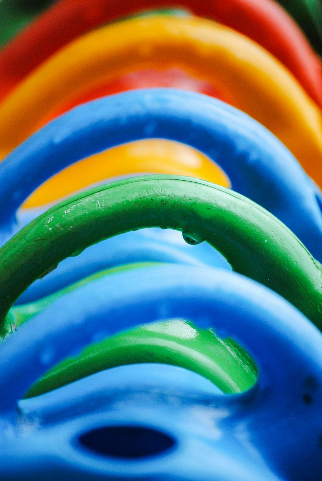 Colorful watering cans with water droplets