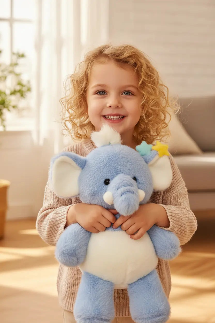 Blue plush elephant toy held by a person with a visible brand tag.